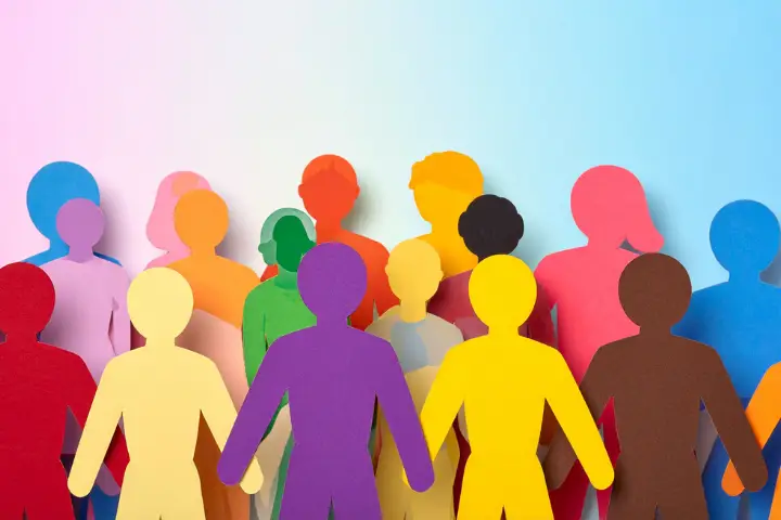 Colorful cutouts of people standing together.