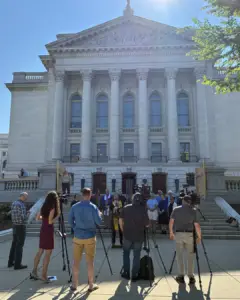 Reporters and clergy at the capitol.