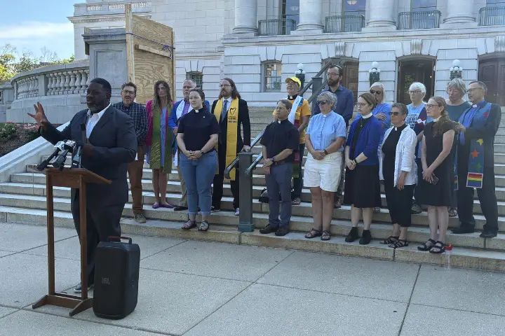 Rev. David Hart speaking at press conference in front of clergy colleagues at the state capitol.